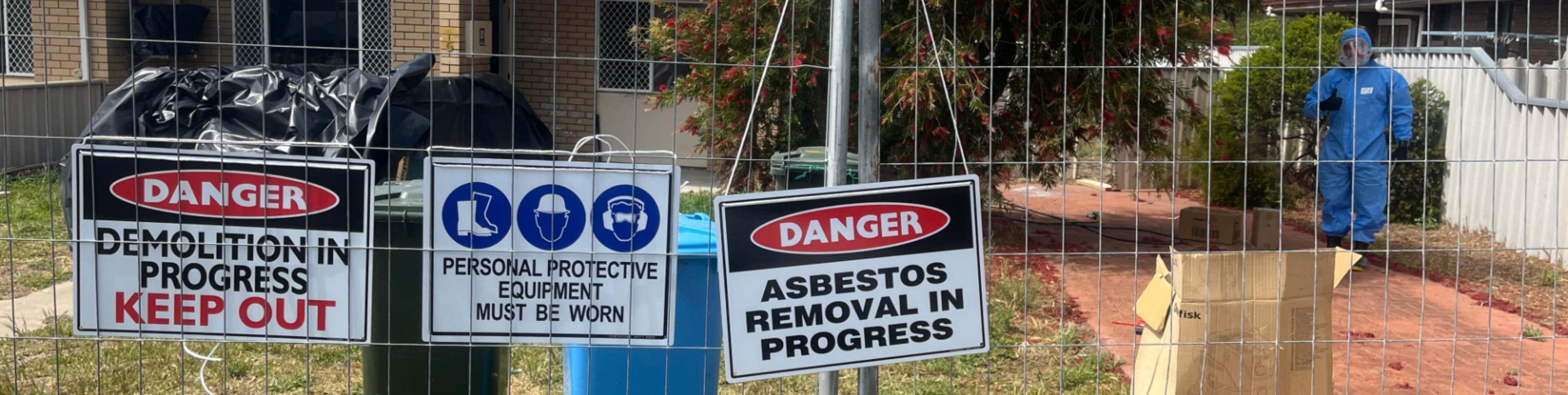 Asbestos removal in progress signage and site fencing